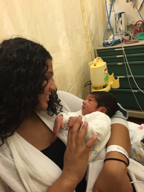 Woman holding son in NICU