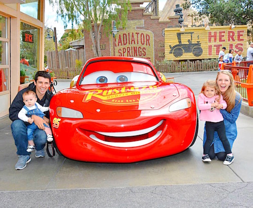 Family posing with Lightning McQueen.