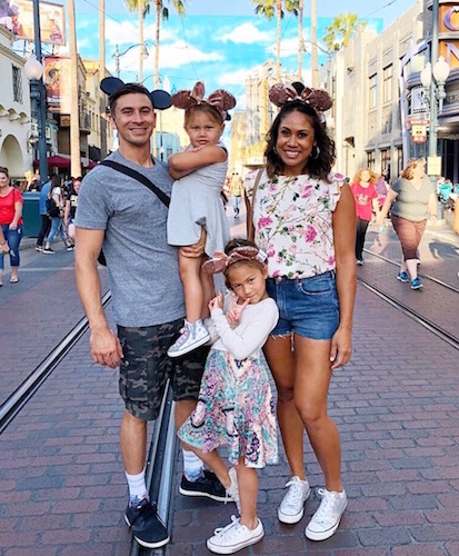 Family with Mickey and Minnie Mouse ears in Disney.