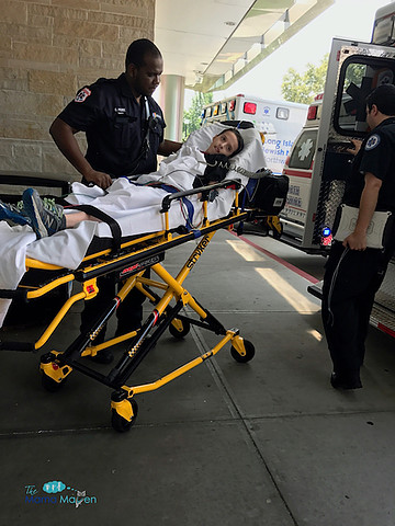 Boy being put in ambulance on a stretcher. 