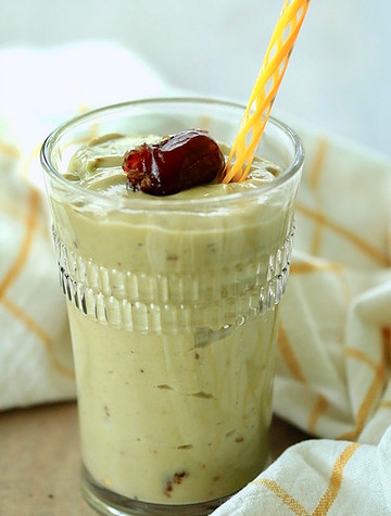 Glass filled with date smoothie.