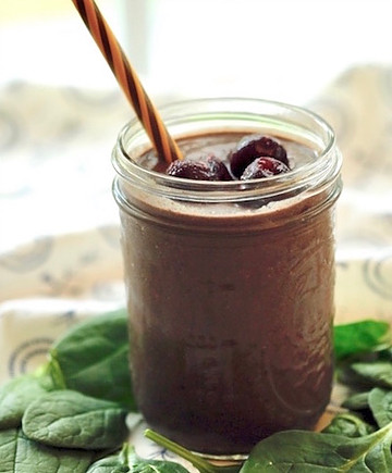 Glass filled with cherry-chocolate smoothie.